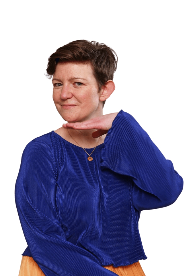 Molly, a white woman with short brown hair is smiling with her hand under her chin.